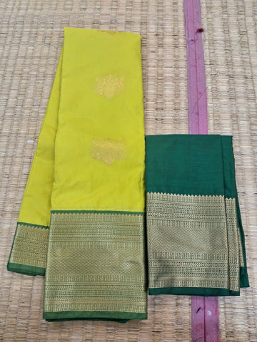 KSS338 Kanjivaram Semi Silk Saree In Yellow w/ Dark Green Border. Fall Peco done. Comes w/ stitched blouse size: 38 to 46.