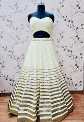 AFL1055-Chiffon Lehenga in lemon yellow comes with vertical stripes gold Zari work on the border and  with Net Dupatta. Also Comes with a matching stitched corset blouse and jacket.