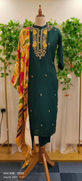 RFSS1540 - party wear silk suit in Bottle green with heavy embroidery on the yoke, comes with pure gajji silk dupatta.